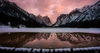 Frozen Toblachersee lake near Toblach, Italy, with Dolomites mountains and their reflection on unfrozen part of the lake on Saturday, 12th of March 2016.
