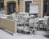 Outdoor cafe tables and chairs under a carpet of snow in Kranj  on 27th of April 2016.
