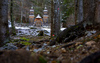 Russian chapel is seen between trees after first snow covered ground on 12th of November 2023. The wooden chapel, dedicated to St. Vladimir was built in 1916 by surviving Russian prisoners of war to commemorate those who died during the construction of the road across Vrsic.