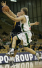 Teemu Rannikko (no. 9) of Union Olimpija (front) scoring while Aleksej Nesovic (no.16) of Zagreb (back) is trying to block him during match of NLB League between Union Olimpija, Ljubljana, Slovenia and KK Zagreb, Croatia. Match ended with victory of Union Olimpija, who defeated Zagreb with 87:76. Match between KK Union Olimpija and Zagreb was played in Tivoli Arena in Ljubljana, Slovenia on 9. December 2006.

