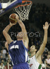 Marton Bader (no.14) of Cibona (L) scoring over Hasan Rizvic (no. 8) of Union Olimpija (R) during match of 8th round of Basketball Euroleague League between KK Union Olimpija, Ljubljana, Slovenia and Cibona Zagreb, Croatia . Match ended with victory of Union Olimpija, who defeated Cibona with 92:88. Match between Union Olimpija and Cibona was played in Tivoli Arena in Ljubljana, Slovenia on 14. December 2006.

