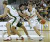 Teemu Rannikko (no. 9) of Union Olimpija (R) attacking while Saulius Kuzminskas (no. 14) of Union Olimpija (L) is making block to  Berni Rodriguez (no.5) of Unicaja (M) during match of 11th round of Basketball Euroleague League between KK Union Olimpija, Ljubljana, Slovenia and Unicaja, Malaga, Spain. Match ended with victory of Union Olimpija, who defeated Unicaja with 87:59. Match between KK Union Olimpija and Unicaja was played in Tivoli Arena in Ljubljana, Slovenia on 10. January 2007.
