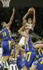 Domen Lorbek (no.23) of Union Olimpija scoring over Tal Burstein (no.10) of Maccabi Elite (L) and Nikola Vujcic (no.7) of Maccabi Elite (R) during match of 13th round of Basketball Euroleague League between KK Union Olimpija, Ljubljana, Slovenia and Maccabi Elite, Tel Aviv, Israel. Match ended with victory of Union Olimpija, who defeated Maccabi Elite with 77:75. Match between KK Union Olimpija and Maccabi Elite was played in Tivoli Arena in Ljubljana, Slovenia on 25. January 2007.
