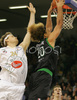 Shaun Stonerook (no.20) of Montepaschi Siena (R) scoring next to Miha Zupan (no.24) of Union Olimpija (L) during match of 8th round of Basketball Euroleague between Union Olimpija, Ljubljana, Slovenia and Montepaschi Siena, Italy. Match between KK Union Olimpija and Montepaschi Siena was played in Tivoli Arena in Ljubljana, Slovenia on 13. December 2007.
