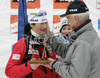 Andreja Koblar of Slovenia (L) receiving sculpture from hand of Peter Zupan, head of Slovene Biathlon, and saying goodbye to her fans, her teammates and coaches of Slovene Biathlon team she finished her last race of her career, women sprint race on Pokljuka, Slovenia. IBU Biathlon World Cup sprint race was held on Pokljuka, Slovenia on 17th of January 2007.
