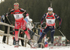 Simon Fourcade of France (R) and Matthias Simmen of Switzerland (L) skiing in men mass start race on Pokljuka, Slovenia. IBU Biathlon World Cup sprint race was held on Pokljuka, Slovenia on 21th of January 2007.
