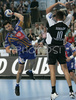 Renato Vugrinec of Portland San Antonio (L) scoring while Sergej Sokolov of RK Gold Club (R) is trying to block during 1/8 finals handball match of EHF Champions League between RK Gold club Hrpelje, Slovenia and Portland San Antonio, Spain. Match was held in Bonifika hall in Koper, Slovenia on 3rd of December 2006. First 1/8 finals match was won by Portland San Antonion with 23:34.
