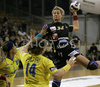 Anja Freser (no.32) of Krim Mercator shooting on goal over Patricia Alonso (no.14) of Cementos la Union-Ribarroja (R) and Marta Mangue (no.99) of Cementos la Union-Ribarroja (L) during Women Handball Championships League match between Krim Mercator and Cem. la Union-Ribarroja. Krim Mercator, Ljubljana, Slovenia was hosting match of 6th round of Women Handball Championships League against Cem. la Union-Ribarroja, Alaquas, Spain, in Tivoli Arena on 24th of February 2007. Match was won by Krim Mercator with result 34:28.
