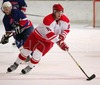 Jannik Hansen of Denmark leading puck while Tadej Pirjevec of Slovenia skating in background during ice hockey match between Slovenia and Denmark on Ice Hockey World Championship Division I, Group A. Denmark won with 3:2, which gives them good chances for winning tournament and qualifying for Elite Division.
