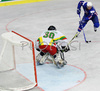 Tomaz Razingar (no.9) of Slovenia (R) infront of goalie Nerijus Dauksevicius (no.30) of Lithuania (L) during match of IIHF Division 1 World championships between Slovenia and Lithuania. Match was won by Slovenia who defeated Lithuania with 4:2. Match was played in Tivoli Arena in Ljubljana, Slovenia on 21. of April 2007.
