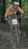 Rok Podbevsek of KD Calcit Kamnik riding during final run of Slovene Cup race in MTB Downhill Kamnik 2006, which was held in Kamnik, Slovenia. Racing was done in extreme conditions caused by heavy rainfall on race day which turned downhill track into mud bath for riders and spectators.
