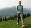 Nordic walker is enjoying her sport on slopes above Bohinj, Slovenia. Nordic walking was first used as a summer training method by cross-country skiers. Nordic walking is one of the fastest growing recreational fitness sports in the world. Nordic walking is fitness walking with specially designed nordic walker poles and offers a very efficient, aerobic and easy way to improve your physical condition irrespective of age, sex or physical condition.
