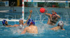 Yann Clay of France (front) is shooting on goal while Slovenian goalie Igor Belofrastov of Slovenia (red cap) is trying to save his goal during first match of qualification waterpolo tournament for European championship. Match between Slovenia and France took place in Kranj, Slovenia on 7.April 2006. Slovenia defeated France with 9:7.
