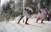 Sean Crooks of Canada (R) and his teammate Jesse Heckrodt (L) skiing during Under-23 Men FIS Nordic Junior Ski World Championships 15+15km pursuit race which was held in Medvode,  Slovenia.
