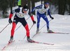 Matthew Johnson of USA (L) and Joel Heer of Switzerland (R) skiing during Junior Men FIS Nordic Junior Ski World Championships 4x5km relay race which was held in Medvode,  Slovenia. Race was won by Norway, Russia placed second, while relay of Czech finished third.
