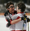 Winner Dario Cologna of Switzerland (L) celebrating with his teammate second placed Curdin Perl of Switzerland (R) in finish area of Men 15+15km pursuit race of Under23 Nordic skiing World Championships in Tarvisio, Italy. Men 15+15km pursuit race of Junior Nordic skiing World Championships in Tarvisio, Italy was held on 17th of March 2007 in Fusine, Italy. Due warm weather and lack of snow, cross country skiing races of Junior Nordic skiing World Championships 2007 were moved from Tarvisio, Italy to Fusine, Italy.
