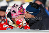 Janica Kostelic of Croatia, left, gets a kiss from an unidentified man during the mens alpine ski World Cup Giant Slalom race in Alta Badia, Italy, Sunday, December 20, 2009.
