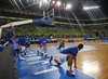 Finnish players warming up, while injured Hanno Mottola (no.13) of Finland (L) observing them before start of the FIBA European basketball championships 2013 match of second round between Finland and Slovenia. Match between Finland and Slovenia was played on Monday, 16th of September 2013 in Stozice arena in Ljubljana, Slovenia.
