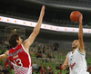 Nebojsa Joksimovic (no.7) of Union Olimpija (R)  shooting over Boban Marjanovic (no.13) of Crvena Zvezda (L) during match of 4th round of ABA Basketball League between Union Olimpija, Slovenia, and Crvena Zvezda, Serbia. Match of ABA Basketball League between Union Olimpija, Slovenia, and Crvena Zvezda, Serbia, was played on Sunday, 20th of October 2013 in Stozice arena in Ljubljana, Slovenia.
