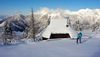 Ski tourer during ski tour in Velika Planina above Kamnik, Slovenia on sunny Saturday, 20th of February 2016.
