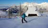 Ski tourer during ski tour in Velika Planina above Kamnik, Slovenia on sunny Saturday, 20th of February 2016.
