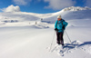 Ski tourer enjoying beautiful views during ski tour in Velika Planina above Kamnik, Slovenia on sunny Saturday, 20th of February 2016.
