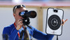 Finnish coach helping Kaisa Makarainen of Finland during zeroing before start of the women IBU E.on Biathlon World cup mass start race in Pokljuka, Slovenia. 12.5km long women mass start race of IBU E.on Biathlon World cup was held on Sunday, 9th of March 2014 in Pokljuka, Slovenia.
