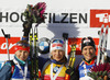 Winner Kaisa Makarainen of Finland (M), second placed Ekaterina Glazyrina of Russia (L) and third placed Anais Bescond of France (R) celebrate their medals won in Women pursuit race of IBU Biathlon World Cup in Hochfilzen, Austria. Women pursuit race of IBU Biathlon World cup was held on Sunday, 14th of December 2014 in Hochfilzen, Austria.
