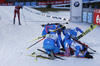 Team of Russia with Alexey Volkov, Evgeniy Garanichev, Dmitry Malyshko and Anton Shipulin celebrating in finish area while Emil Hegle Svendsen of Norway is exhausted and disappointed in background during the Men relay race of IBU Biathlon World Cup in Hochfilzen, Austria. Men relay race of IBU Biathlon World cup was held on Sunday, 13th of December 2015 in Hochfilzen, Austria.
