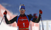 Winner Simon Schempp of Germany crossing finish line and celebrating his victory in the Men pursuit race of IBU Biathlon World Cup in Pokljuka, Slovenia. Men pursuit race of IBU Biathlon World cup was held on Saturday, 19th of December 2015 in Pokljuka, Slovenia.
