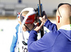 Finnish coach Marko Laaksonen trying to solve problems on Kaisa Makarainen rifle during zeroing before start of the Women pursuit race of IBU Biathlon World Cup in Pokljuka, Slovenia. Women pursuit race of IBU Biathlon World cup was held on Saturday, 19th of December 2015 in Pokljuka, Slovenia.
