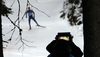TV cameraman during the Men mass start race of IBU Biathlon World Cup in Pokljuka, Slovenia. Men mass start race of IBU Biathlon World cup was held on Sunday, 20th of December 2015 in Pokljuka, Slovenia.
