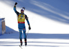 Winner Martin Fourcade of France celebrating his victory while crossing finish line during the men pursuit race of IBU Biathlon World Cup in Pokljuka, Slovenia.  Men pursuit race of IBU Biathlon World cup was held in Pokljuka, Slovenia, on Saturday, 10th of December 2016.
