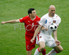 Switzerlands defender Stephan Lichtsteiner, left, fights for the ball with Czech Republics forward Jan Koller during the Euro 2008 Group A soccer match between Switzerland and Czech Republic at the St. Jakob Park (Joggeli) stadium in Basel, Switzerland, Saturday June 7, 2008. <br> 
