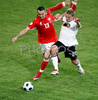 Polands defender Marcin Wasilewski, left, fights for the ball with Germanys forward Lukas Podolski during the Euro 2008 Group B soccer match between Germany and Poland at the Woerthersee stadium in Klagenfurt, Austria, Sunday June 8, 2008.
