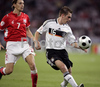 Germanys defender Philipp Lahm, right, fights for the ball with Polands midfielder Euzebiusz Smolarek during the Euro 2008 Group B soccer match between Germany and Poland at the Woerthersee stadium in Klagenfurt, Austria, Sunday June 8, 2008.
