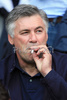 AC Milans coach Carlo Ancelotti smokes a cigarette during the Euro 2008 Group C soccer match between Netherlands and Italy at the Stade de Suisse stadium in Berne, Switzerland, Monday June 9, 2008.
