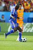 Frances defender Lilian Thuram, left, kicks the ball while Romanias forward Daniel Niculae looks on during the Euro 2008 Group C soccer match between Romania and France at the Letzigrund stadium in Zurich, Switzerland, Monday June 9, 2008.
