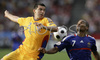 Romanias defender Cosmin Contra, left, fights for the ball with Frances midfielder Florent Malouda during the Euro 2008 Group C soccer match between Romania and France at the Letzigrund stadium in Zurich, Switzerland, Monday June 9, 2008.
