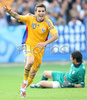 Romanias forward Adrian Mutu reacts after scoring against Italy while Italys goalkeeper Gianluigi Buffon lies on the ground during the Euro 2008 Group C soccer match between Italy and Romania at the Letzigrund stadium in Zurich, Switzerland, Friday June 13, 2008.
