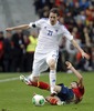 Kasper Hamalainen of Finland (L) and Sergio Busquets of Spain (R) during the FIFA World Cup Qualifier Match between Spain and Finland at the El Molinon Stadium, Gijon, Spain, on Friday, 22nd of March 2013.
