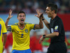 Mikael Lustig of Sweden and referee Gianluca Rocchi during FIFA World Cup Qualifier Match between Austria and Sweden. FIFA World Cup Qualifier Match between Austria and Sweden was played on Ernst Happel Stadium in Vienna, Austria, on Friday, 7th of June 2013.

