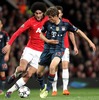 Marouane Fellaini #31 (Manchester United) and Thomas Mueller #25 (FC Bayern Muenchen) during the UEFA Champions League Round of 8, 1nd Leg match between Manchester United and FC Bayern Muenchen at the Old Trafford in Manchester, Great Britain on 2014/04/01.
