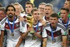 Sami Khedira, Philipp Lahm and Thomas Mueller (GER) celebrate with winning trophy after Final match between Germany and Argentina of the FIFA Worldcup Brazil 2014 at the Maracana in Rio de Janeiro, Brazil on 2014/07/13. 
