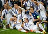 Real Madrids celebrate with the trophy after their 2-0 victory over Sevilla during the UEFA Super Cup at the Cardiff City Stadium. Cristiano Ronaldo, Gareth Bale, goalkeeper Iker Casillas, Isco, Sergio Ramos, head coach Carlo Ancelotti during the UEFA Supercup Match between Real Madrid and FC Sevilla at the Millenium Stadium in Cardiff, Cardiff on 2014/08/12.
