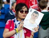 A Real Madrid supporter kisses a photograph of Gareth Bale during the UEFA Supercup Match between Real Madrid and FC Sevilla at the Millenium Stadium in Cardiff, Cardiff on 2014/08/12.
