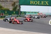 Sebastian Vettel (Scuderia Ferrari) taking lead in first corner infront of Nico Rosberg (Mercedes AMG Petronas Formula One Team) and Kimi Raeikkoenen (Scuderia Ferrari) during the race of the Hungarian Formula One Grand Prix at the Hungaroring in Budapest, Hungary on 2015/07/26.
