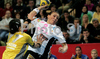 Lenka Kysucanova (no.2) of Metz Handball (R) shooting next to Andrea Lekic (no.77) of RK Krim (L) during second round match of Women Champions league between RK Krim, Ljubljana, Slovenia, and Metz Handball, Metz, France. Match between RK Krim and Metz Handball was played on 9th of November 2008 in Kodeljevo Arena in Ljubljana, Slovenia. Match ended with victory of Metz, who defeated RK Krim with 26:31.

