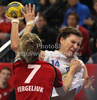 Karolina Kudlacz (no.14) of HC Leipzig (R) shooting while Marina Vergeliuk (no.7) of Krim Mercator (L) is trying to block her during match of EHF Women Handball Champions League between RK Krim Mercator and HC Leipzig. Match of EHF Women Champions League between RK Krim Mercator, Ljubljana, Slovenia and HC Leipzig, Germany, was played in Kodeljevo Arena, Ljubljana, Slovenia, on Saturday, 13th of February 2010. Match was won by RK Krim Mercator, who defeated HC Leipzig with 32-26.
