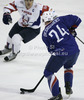 Julien Desrosiers (24) of France and Marcel Rodman (22) of Slovenia during the match of EICH Ice hockey tournament between Slovenia and France. Match between Slovenia and France  was held in Tivoli Arena in Ljubljana, Slovenia, on Friday, 9th of November 2012. during match of EIHC ice hockey tournament between Slovenia and France. Match between Slovenia and France was played in Tivoli Arena in Ljubljana, Sloveni, on Friday, 9th of November 2012. Match was won by Slovenia, who defeated France with 3-1.
